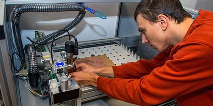 Ein Mann arbeitet an einem elektrischen Gerät.