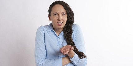 Junge Frau mit fragendem Gesichtsausdruck
